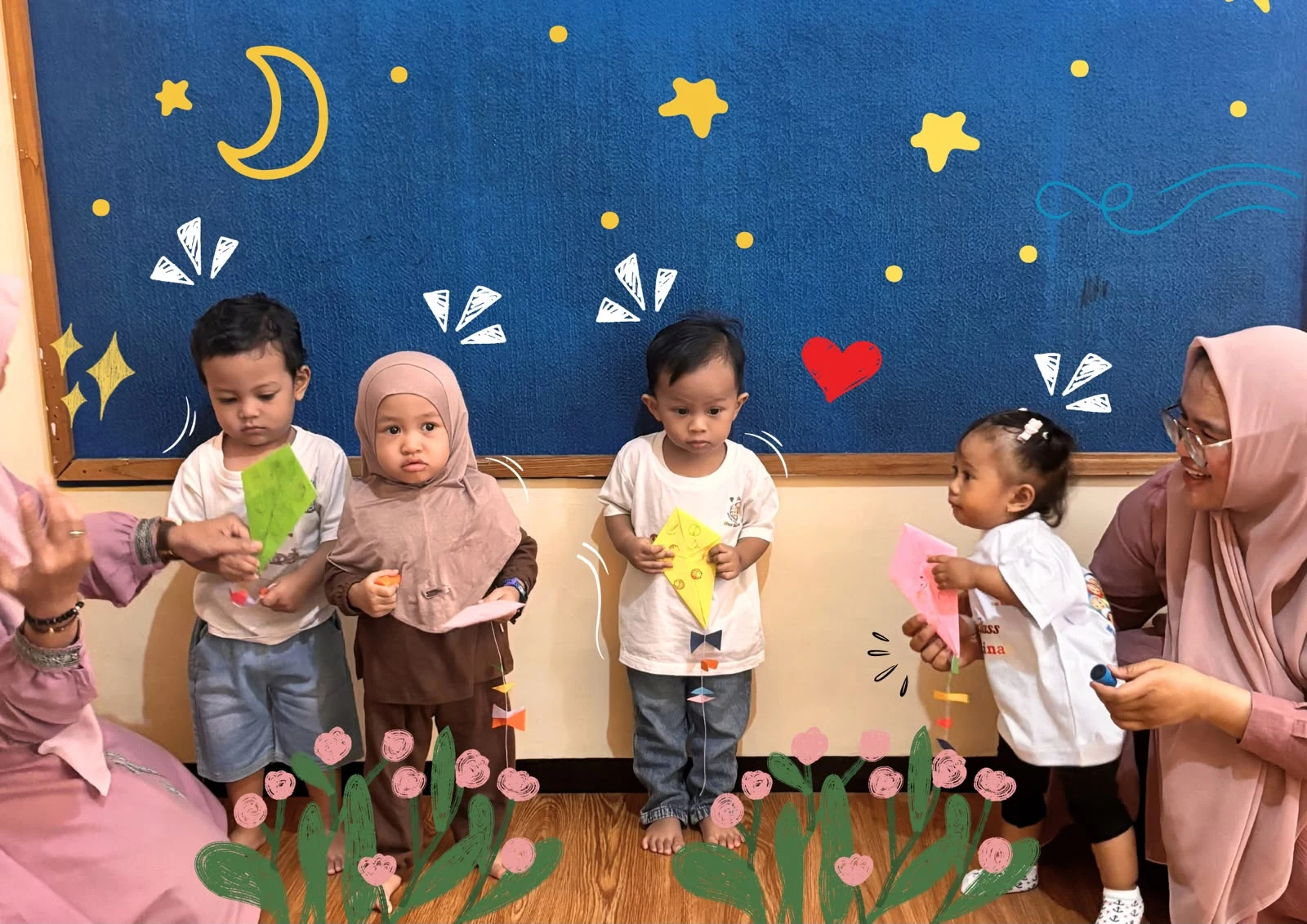 Anak-anak Baby Class Nur Madinah memegang pesawat kertas bersama bunda guru